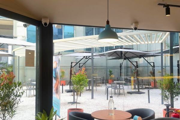 Showcasing a vibrant Blue Tokai outlet, this collection illustrates the premium quality of retail space developed by Infinity Group. From the modern glass interiors and sleek service counters to the relaxing open-air seating zones, these images define the high standard of our shops for rent. For businesses seeking visibility and ambiance, this location offers an exceptional retail space for rent, perfectly blending contemporary architecture with a welcoming customer experience.