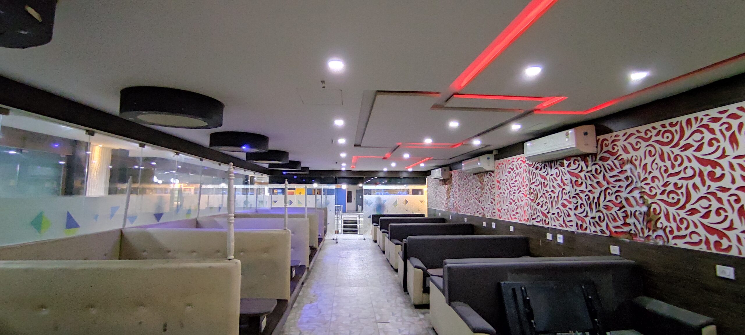 This image displays two separate retail shops side-by-side on the ground floor of an Infinity Group building. This layout suggests a strategic cluster of businesses designed to serve a diverse customer base. The prime retail locations in Salt Lake Sector V allow different brands to benefit from shared footfall, creating a symbiotic relationship. This approach is a key part of the overall location strategy for maximizing sales and customer convenience within the complex