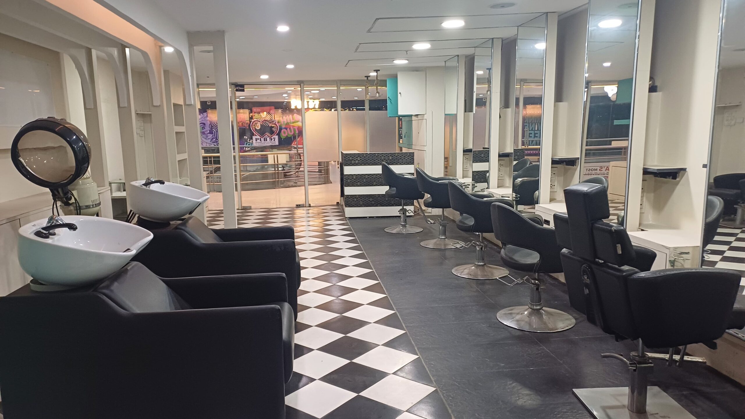 This fully equipped salon setup illustrates the versatility of a retail store space for rent within a Grade-A building. Featuring ergonomic washing stations, large mirrors, and a stylish checkered floor, this retail space is ready for service-oriented businesses to plug and play. Positioned in the heart of Salt Lake Sector 5, it offers direct access to thousands of time-poor office-goers looking for grooming services near their workplace, making it a lucrative location for wellness brands.